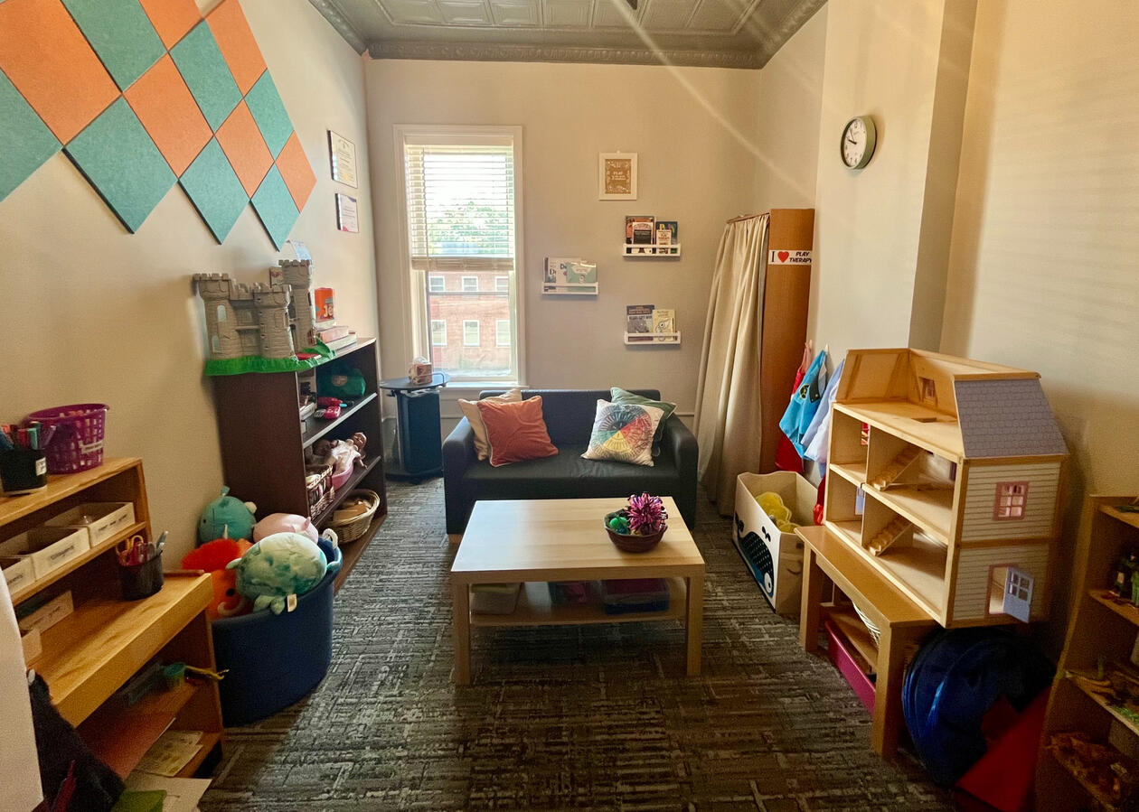 A view of the PAYA Playroom facing toward the back window and away from the front wall.